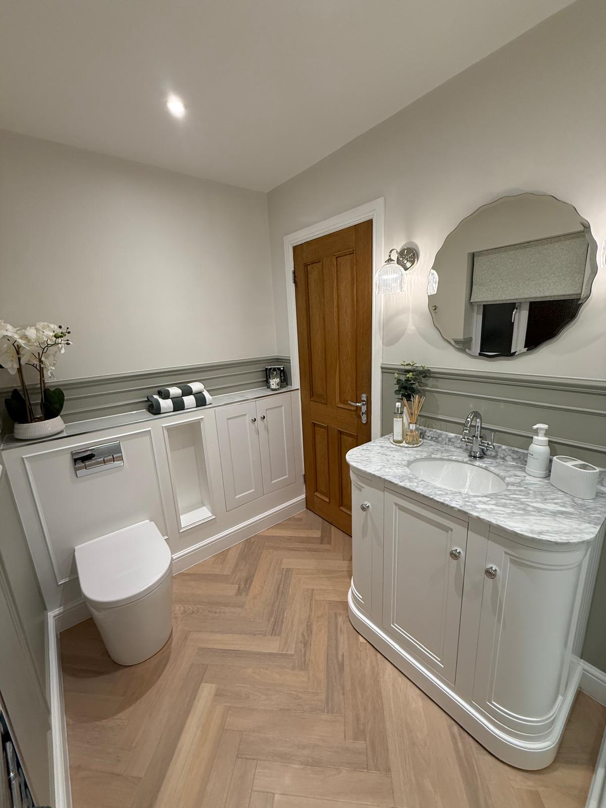 Herringbone bathroom flooring and fitted cabinetry